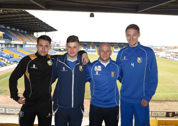 Adam Murray with his three young signings.