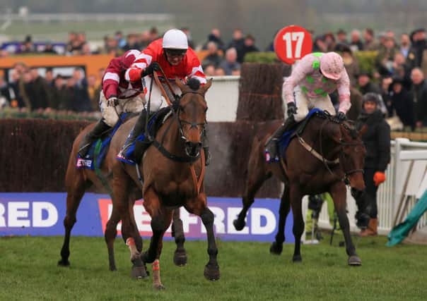 PURE GOLD -- Coneygree fends of Djakadam (right) and Road To Riches to become the first novice to win the Cheltenham Gold Cup for 41 years (PHOTO BY: Nick Potts/PA Wire).