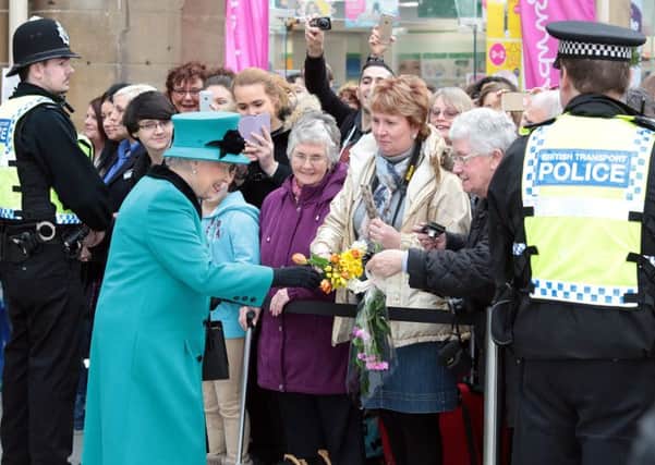 The Queen is greeted by the public at the station