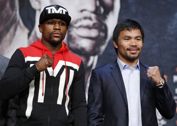 Boxers Floyd Mayweather Jr., left, and Manny Pacquiao pose for photographers during a press conference in Las Vegas.
