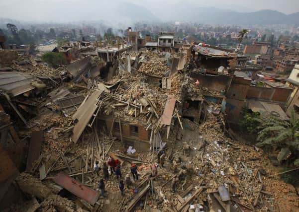 Rescue workers remove debris as they search for victims of earthquake in Bhaktapur near Kathmandu, Nepal. (AP Photo/Niranjan Shrestha)