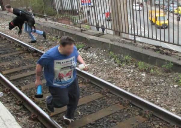 Dramatic moment Mickey Parkes jumped onto the tracks to save the dog