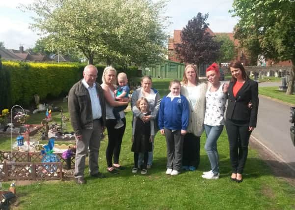 Callous thieves have stolen ornaments, lights and cash from a money box a money box  on at least four graves of stillborn and young babies at Kirkbys Kingsway Cemetery. Families are pictured with MP Gloria De Piero.