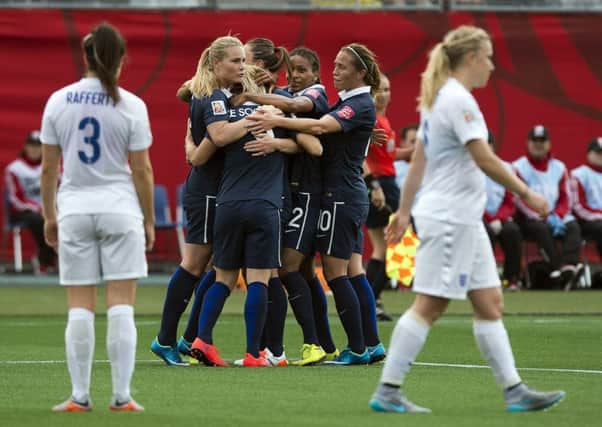 France's Eugenie Le Sommer, center, is congratulated by teammates after scoring against England during the first half of a FIFA Women's World Cup soccer match in Moncton, New Brunswick. Picture by Andrew Vaughan/The Canadian Press via AP.
