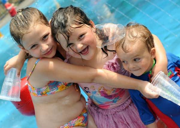 Shakira Ward, Codie Gaskin and Ethan Gaskin keep their cool at the Bulwell Bogs water park as temperatures soar on Wednesday.