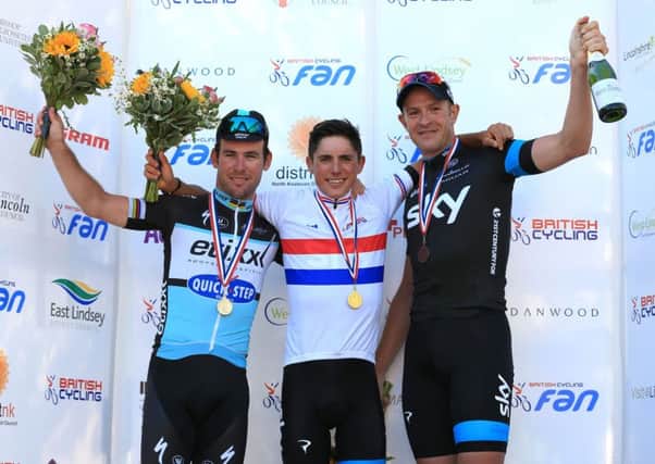 Team Sky's Pater Kennaugh (centre) celebrates winning the the British Cycling National Road Championships in Lincolnshire, along side second placed Etixx - QuickStep Mark Cavendish MBE (left) and thrid placed Team Sky's Ian Stannard. Photo credit: Nigel French/PA Wire