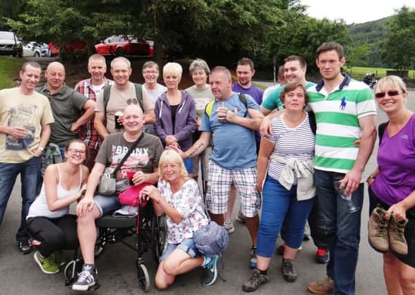 Ian King, who has had his leg amputated after a blood clot, with his Royal Mail colleagues and friends who completed a walk round Chatsworth to raise money for a titanium wheelchair for him.