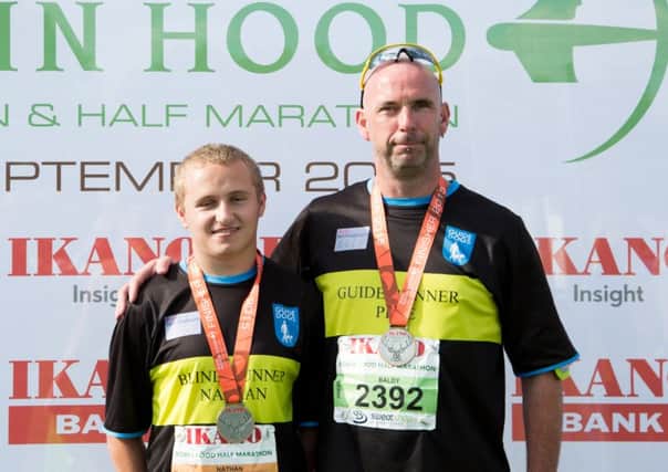 Blind runner Nathan Edge, with his guide runner Pete, after the Robin Hood half marathon