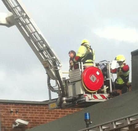 The scene on Vine Terrace in Hucknall when a woman was stuck on the roof of Spot On snooker venue