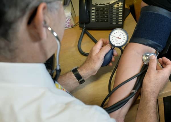 Embargoed to 0005 Friday November 6
File photo dated 10/09/14 of a GP checking a patient's blood pressure. Most people have no interest in their GP surgery opening at weekends, a survey of almost a million patients has found. PRESS ASSOCIATION Photo. Issue date: Friday November 6, 2015. In a further blow to Prime Minister David Cameron's pledge to introduce seven-day services, new research showed that 81% of patients do not find current GP opening times inconvenient. See PA story HEALTH GPs. Photo credit should read: Anthony Devlin/PA Wire