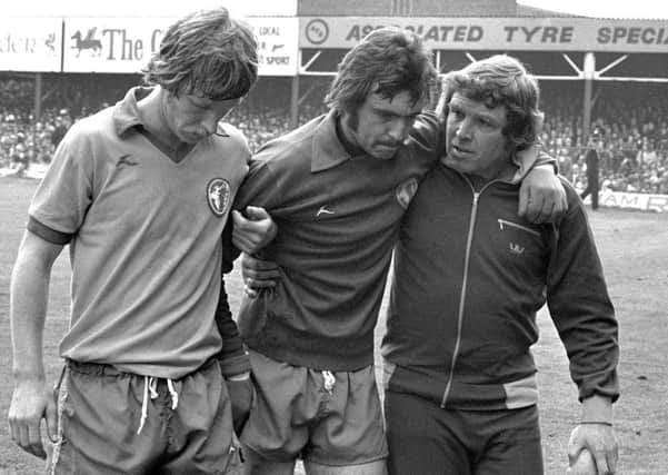 Rod Arnold is helped off the pitch with concussion at Wrexham on the day the Stags won the Third Division title  in 1976/77