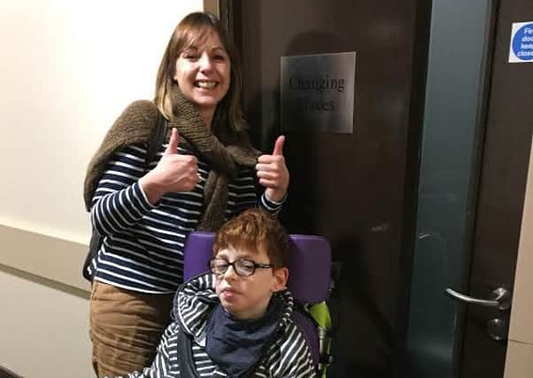 Alison Beevers and Mylor outside an accessible Changing Places toilet