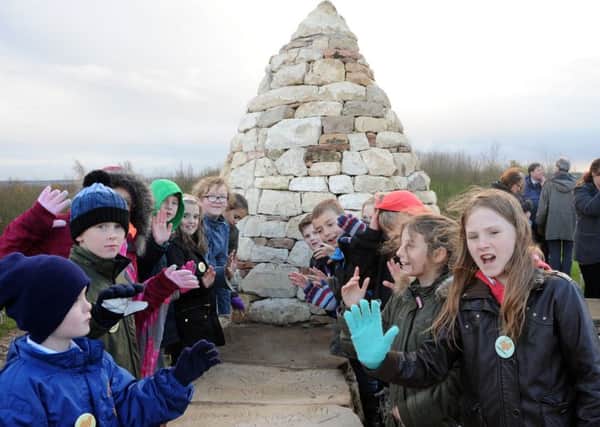 School pupils from Whaley Thorns, who left their hand prints in the 'Top of the World' sculpture at Poulter Park, visit the site at it's launch on Tuesday.