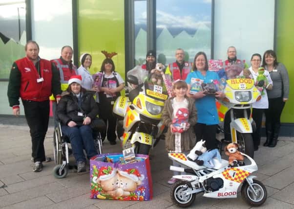 A selection of the gifts collected last year, (2014) with Blood Bike volunteers and childrens ward staff.