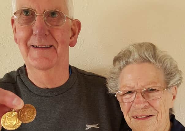 Denis and Betty Ball with some of Nobby Clarke's football medals.