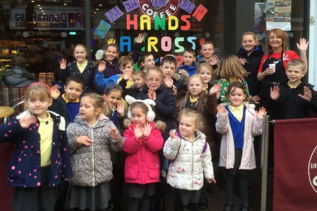 School children contributed outlines of their hands for an art project at Costa Coffee in Hucknall