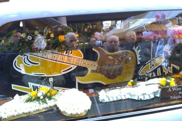 Well wishers pay tribute to busker Ray Froggatt. His musical themed coffin  is displayed as the cortege passes Mansfield Four Seasons shopping centre where he busked for more than 30 years.