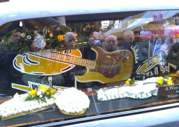 Well wishers pay tribute to busker Ray Froggatt. His musical themed coffin  is displayed as the cortege passes Mansfield Four Seasons shopping centre where he busked for more than 30 years.