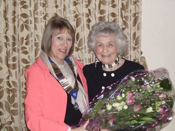 President Shirley presenting Marjorie with a bouquet.