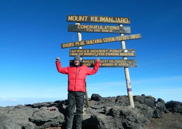 Paul Pounder at the summit of Mount Kilimanjaro