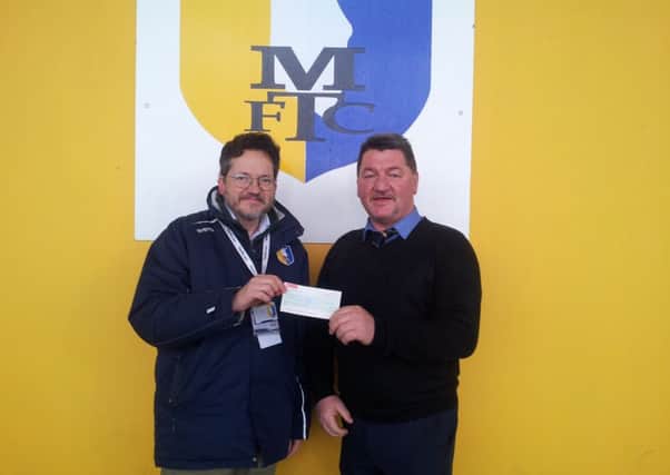 Martin Shaw presents the cheque to Steve Hymas.