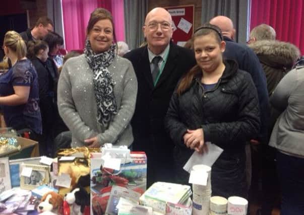 Coun John Wilmott with Jemma Hankinson and Lisa Bobbington looking at their glittertattoos and face painting equipment