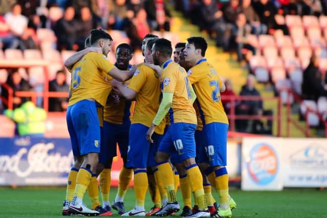 Mansfield Town players congratulate goalscorer Ryan Tafazolli - Picture Chris Holloway