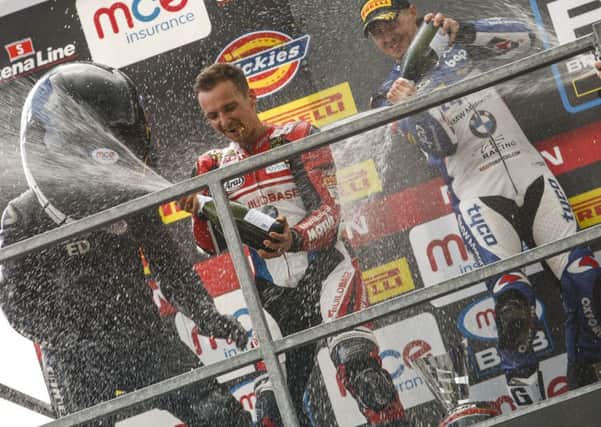 Richard Cooper (centre) celebrates his win on the podium at Oulton Park.