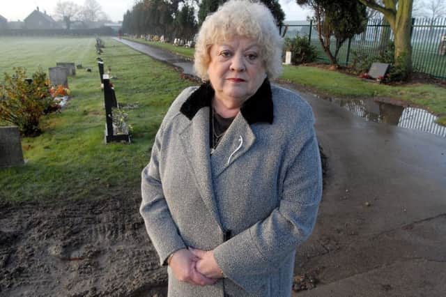 09-3170-1
Carol Ridley- Barker at Hucknall cemetery  were than has been some flooding
