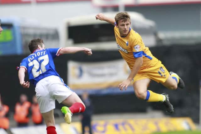 Liam Marsden in high flying action with Carlisle's Tom Elliott -Pic by: Richard Parkes