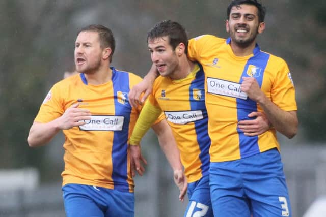 Matty Blair is mobbed after equalising for Mansfield - Pic by: Richard Parkes