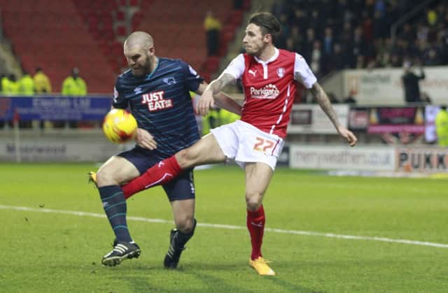 Rotherham's Matt Derbyshire tangles with Derby's Jake Buxton-Pic by: Richard Parkes