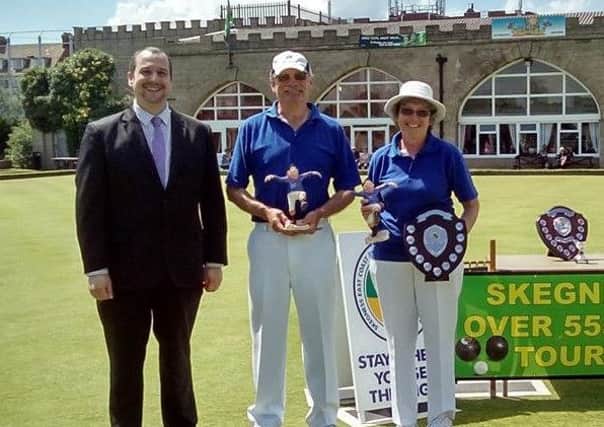 HAPPY ADAMS FAMILY -- Hucknall bowlers Dave and Janet Adams receive their latest Skegness prizes from Carl Vasey.