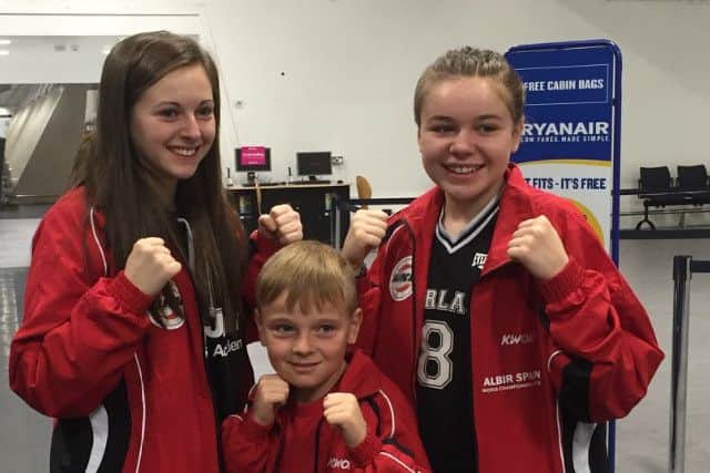 KEEPING IT IN THE FAMILY -- Josie (left) and sister Lucie Callan, with their younger brother, Kyle.