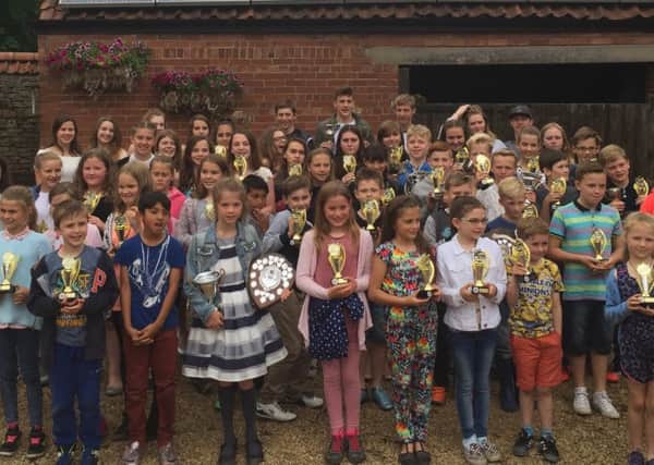 WINNERS ALL -- Hucknall Falcon swimmers line up with their trophies and awards.