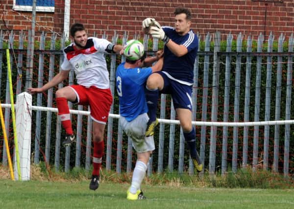 CRUNCH! -- action from the Horace Hibbert Shield pre-season derby between Kimberley Miners Welfare and Eastwood Community.