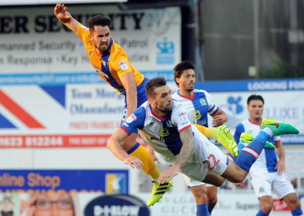 Mansfield Town v Blackburn Rovers.
Chris Clements goes flying in on goal ahead of Shane Duffy.