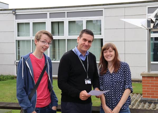 Holgate Academy students Will Humphreys and Jessica Richards celebreate their A-Level grades, pictured with head Neil Holmes.