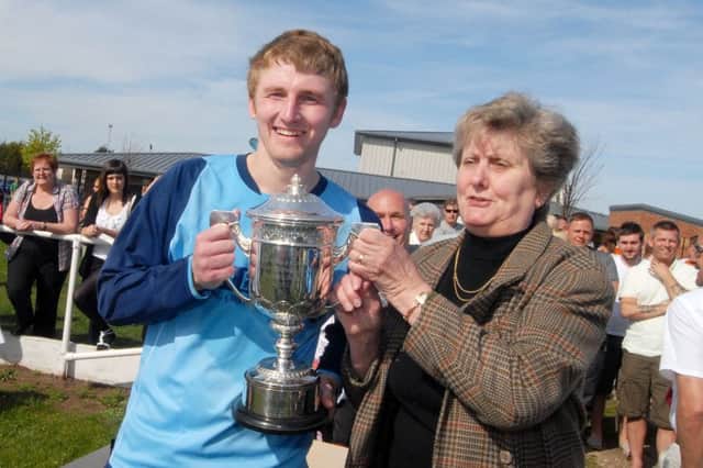 Langwith Jug and Glass captain Dave Ragsdale is presented with the Mansfield Sunday League Premier Cup in 2011 by Kath Rowan after their win over Linden Jacques. NMAC11-0930-6