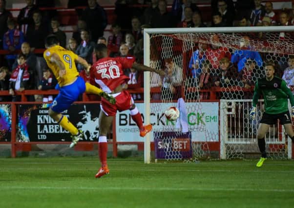 Mansfield Town's Patt Hoban heads for goal - Pic by Chris Holloway