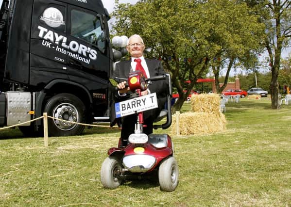 Barry Taylor next to a  special truck painted  to celebrate 40 years for B. Taylor And Sons Transport Ltd and 10 years for Taylors Transport International Ltd.