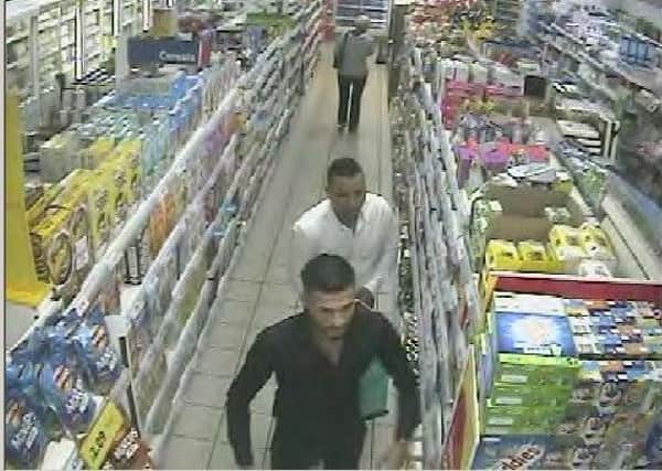 Police would like to speak to these two men in connection with a shop theft in Eastwood.