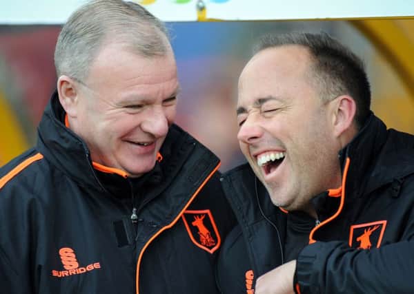 Steve Evans shares a joke with new fitness coach Lee Taylor in the dug out on Saturday.