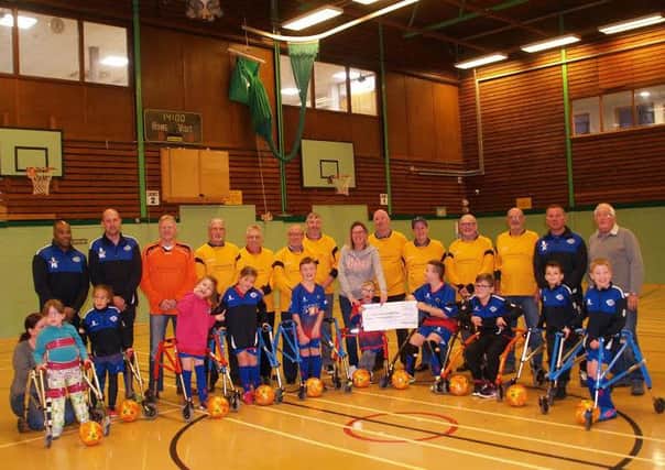 Hucknall's Geri-Hat-Tricks Walking Football Group presented the Rolls Royce Frame Football Club with a cheue for Â£350