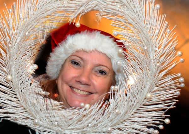 Jackie Markham surrounds herself with all things Christmasy during the Festival on the Market Place in Hucknall on Wednesday.