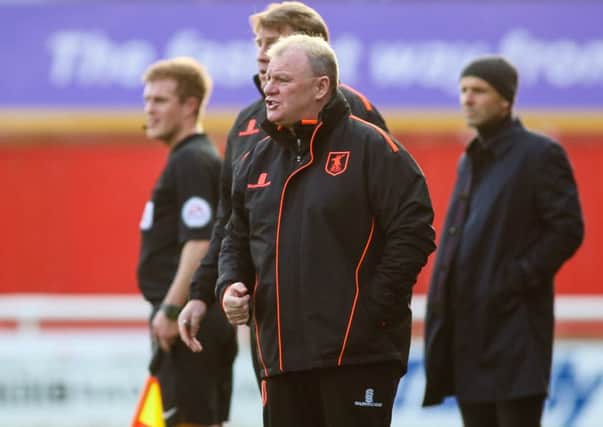 Steve Evans oversees the action at Exeter on Saturday. Photo by Chris Holloway.