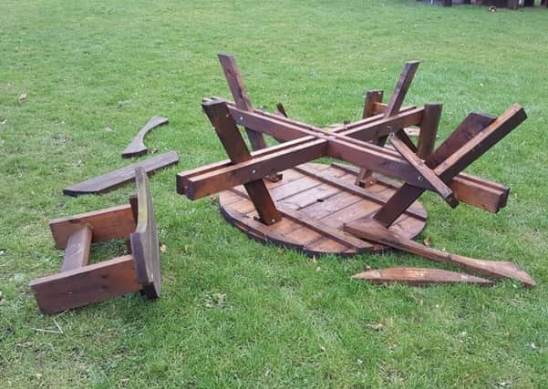 One of the community gardens picnic tables that was upturned and smashed by the vandals.