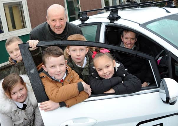 The camera enforcement car is greeted by pupils at Broomhill Junior School, Hucknall, with Coun Steve Calvert, of Nottinghamshire County Council, and  enforcement manager Gareth Johnson in the drivers' seat. (PHOTO BY: Anne Shelley)