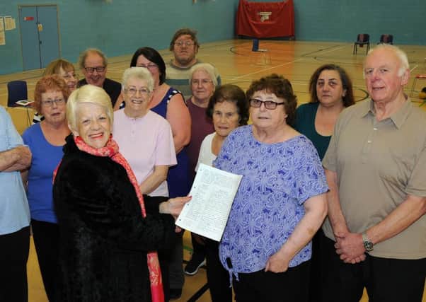 Coun. Jackie Morris is presented with a petition by members of a keep fit class held at the gymnasium in the Riverside complex which is under threat.