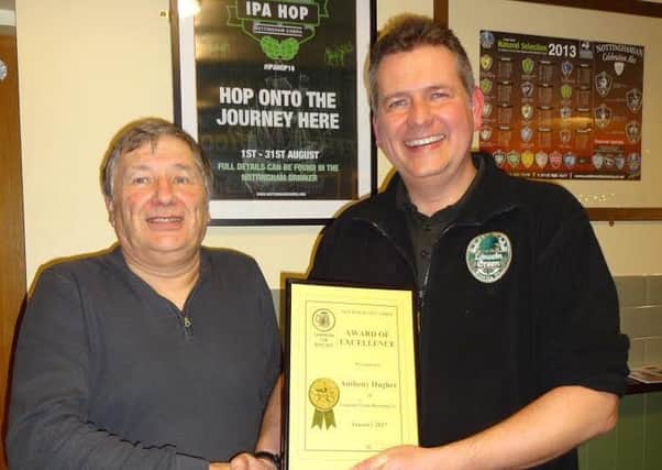 Nottingham CAMRA chairman Steve Westby (left) presents Anthony Hughes with his award of excellence.